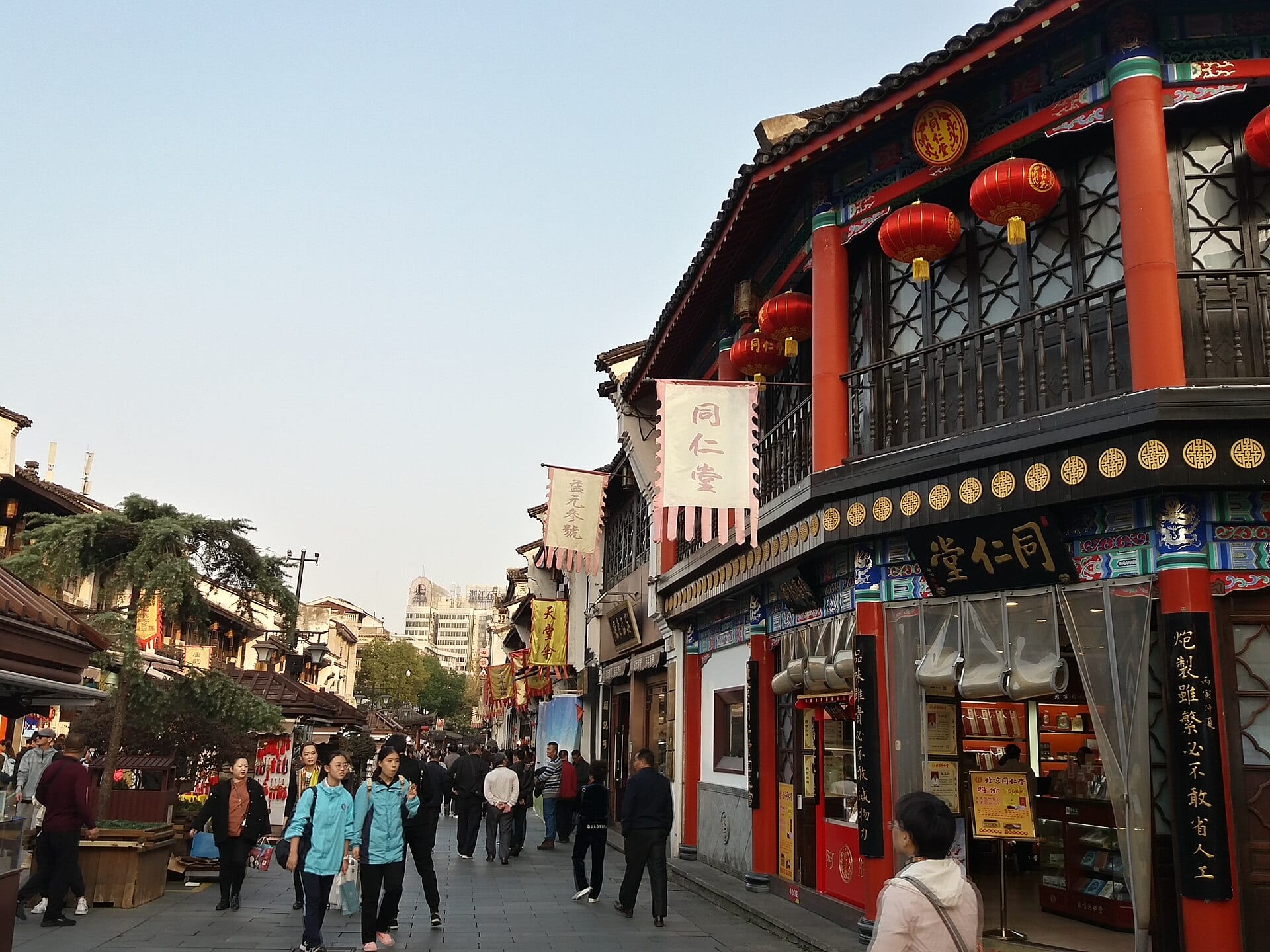 Shoppers and traditional storefronts along bustling Hefang Street