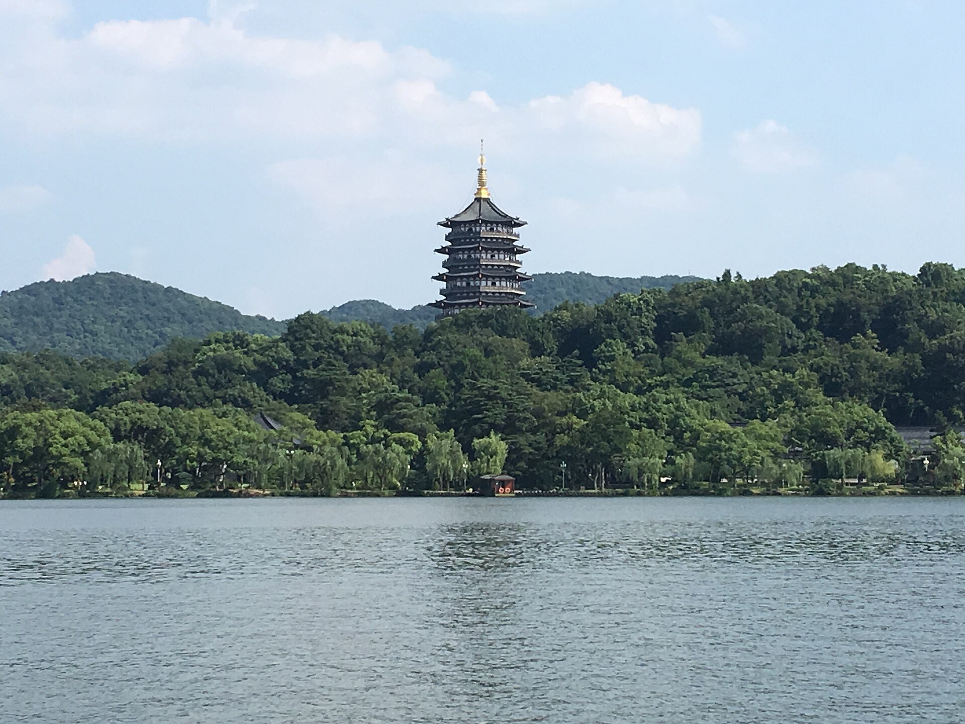 Leifeng Pagoda rising above the wooded shore of West Lake