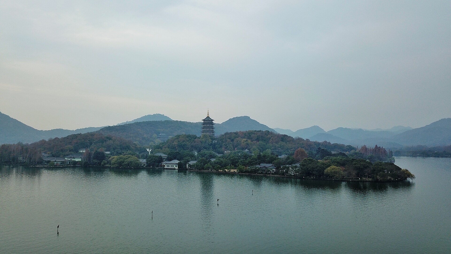 Leifeng Pagoda rising above the wooded edge of West Lake